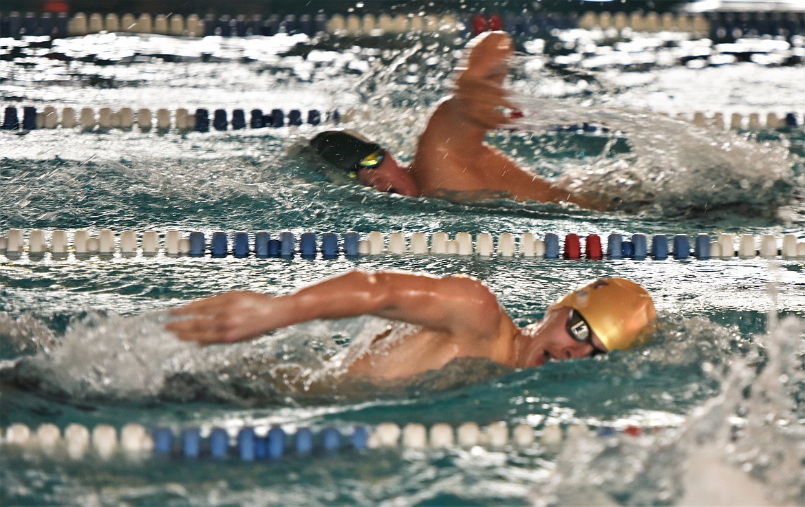 Polson's Mason Sloan, foreground, passes Hardin's Wynn Walks Over Ice during his final lap of the 200 freestyle. (Scot Heisel/Lake County Leader)