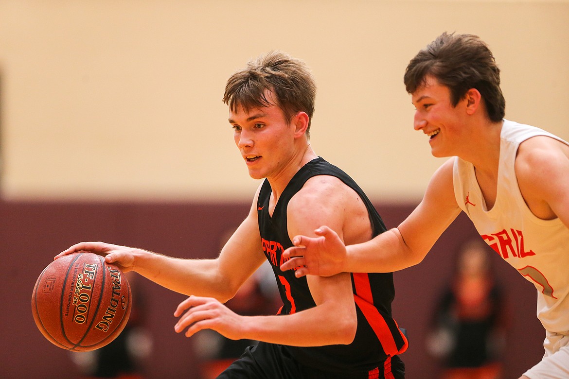 Junior Jordan Nortz looks to drive toward the basket while a Fruitland player defends him in a 3A state consolation game last Friday. Nortz earned a spot on the all-league team.