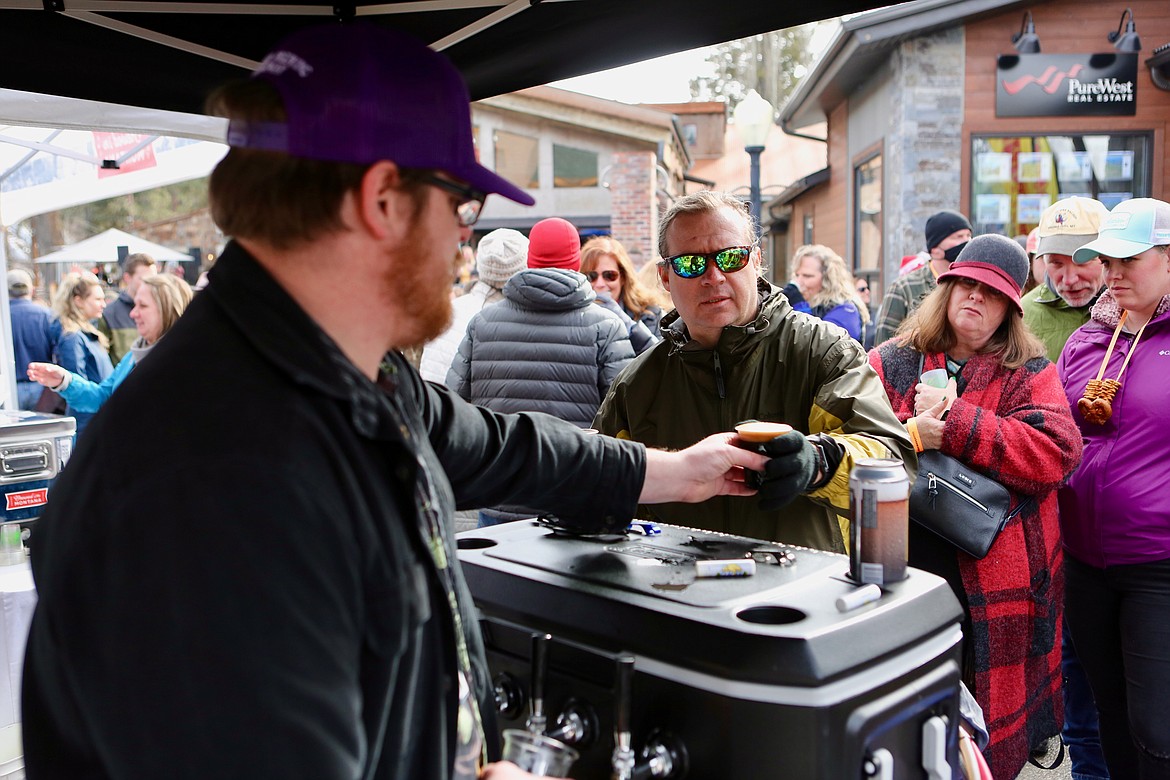 Patrick May, lead beertender with Glacier Brewing, pours a brew for a patron at Bigfork Beerfest. 
Mackenzie Reiss/Bigfork Eagle