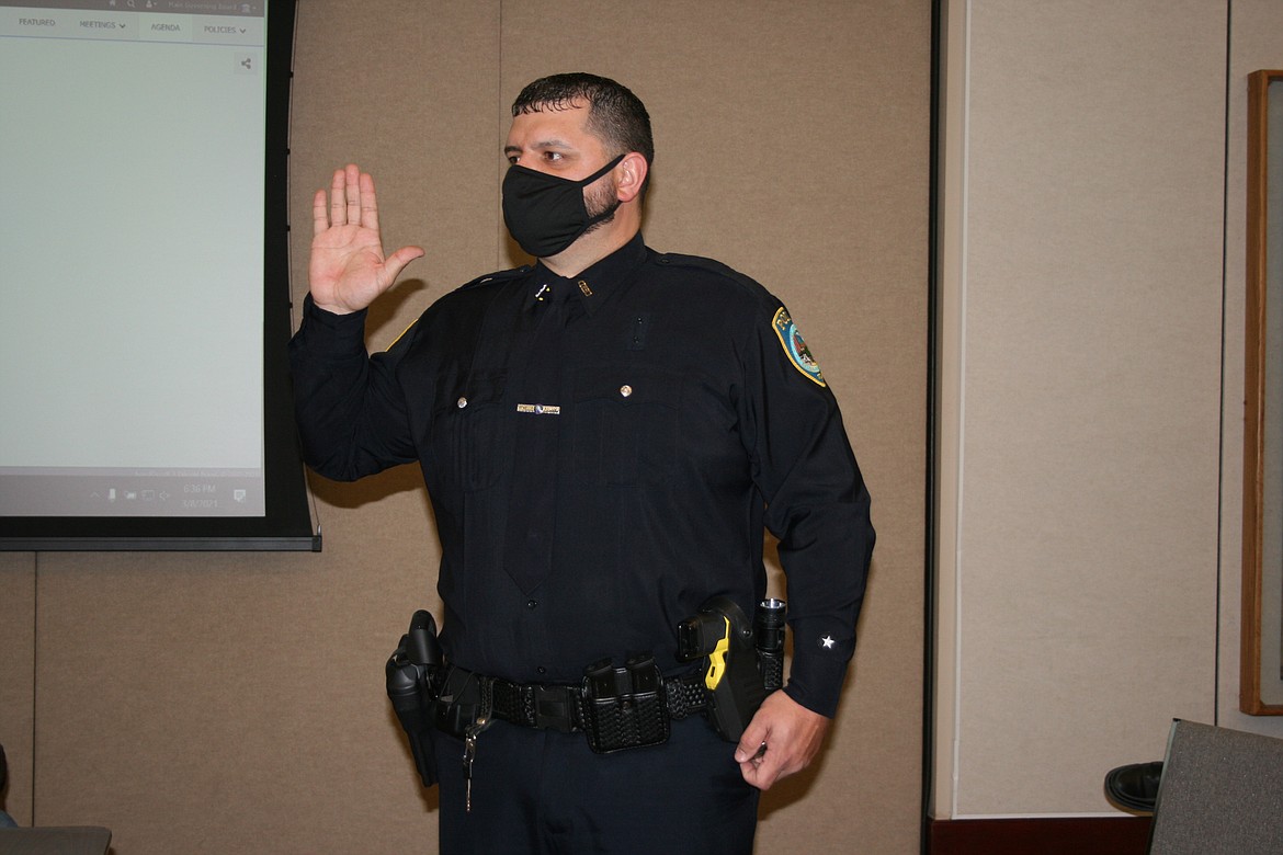 New Othello Police Officer Tyson Cox takes the oath of office during the Othello City Council meeting Monday.