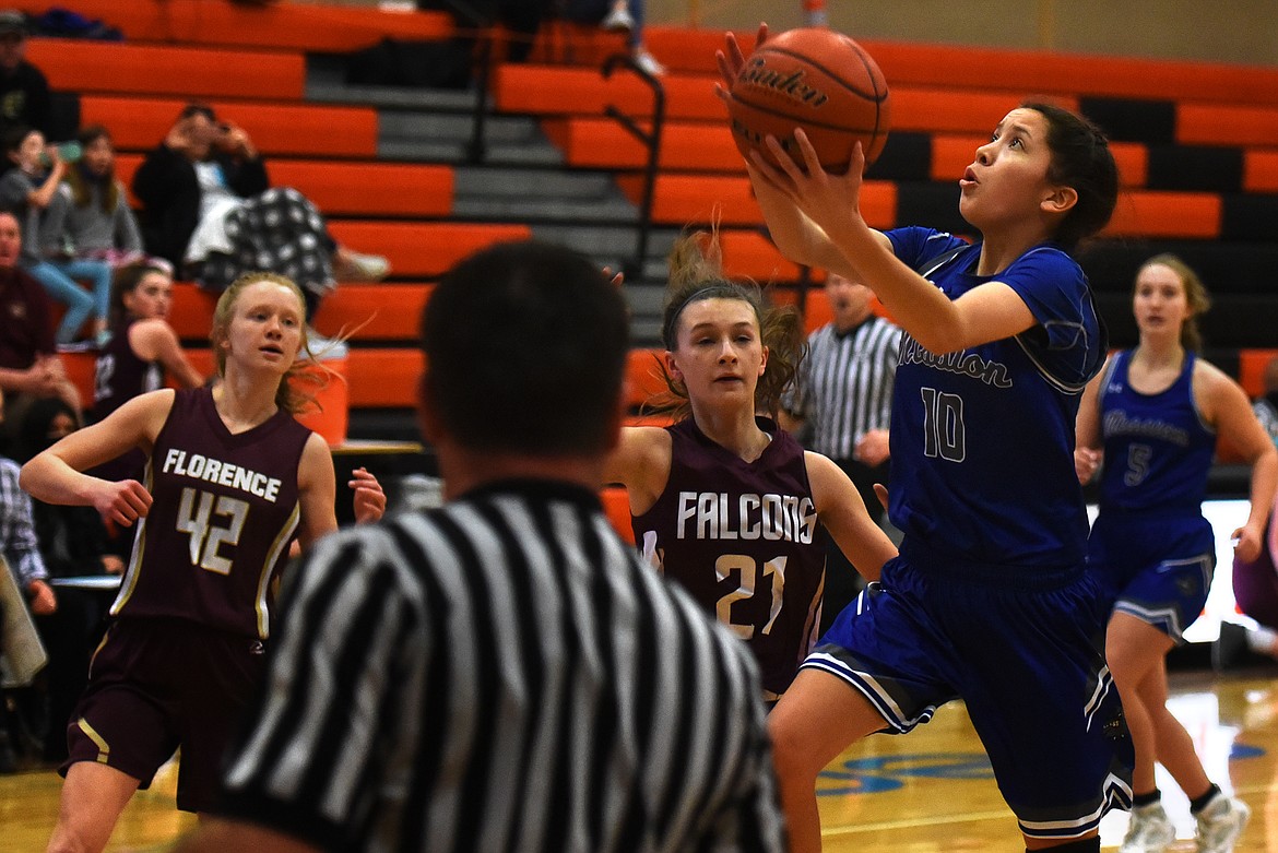 Mission's Madyson Currie drives to the basket for two points against Florence. (Jeremy Weber/Bigfork Eagle)