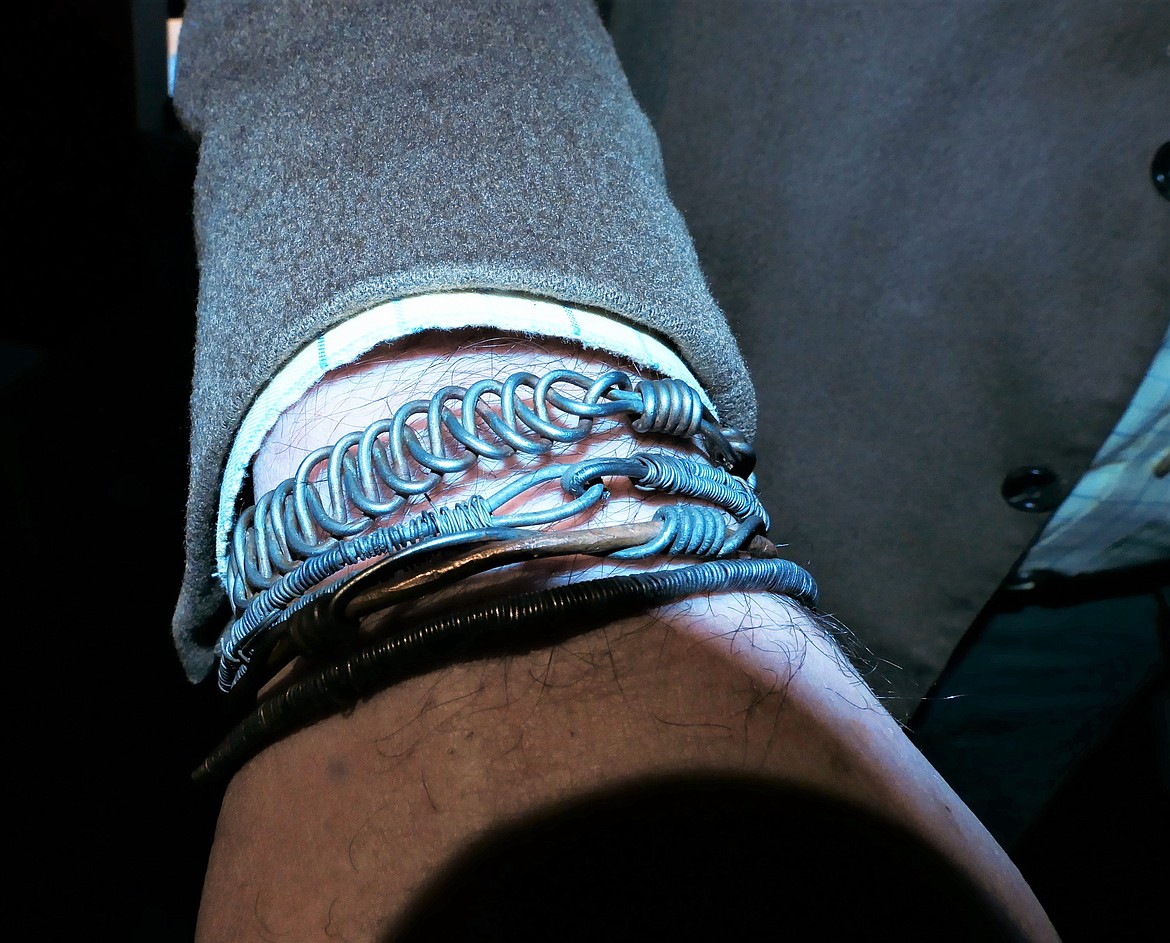 Filmmaker Tom Opre of Whitefish displays bracelets made of wire from confiscated snares in Lower Luano area of Zambia. Bracelet sales by his nonprofit, Shepherds of Wildlife Society, fund a small loan program that helps women start small business in the Shikabeta communities. (Carolyn Hidy)