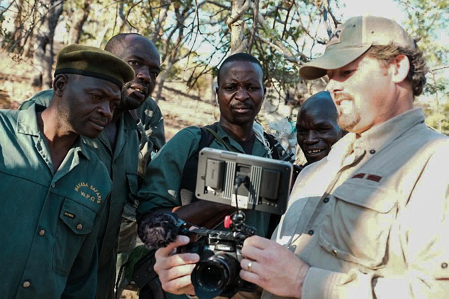 Filmmaker Tom Opre of Whitefish shows footage to Makasa Safaris game scouts in Zambia. Opre's film "Killing the Shepherd" was screened at the Flathead Lake International Cinemafest, FLIC 2021, in late January in Polson. (Courtesy of Tony Bynum)