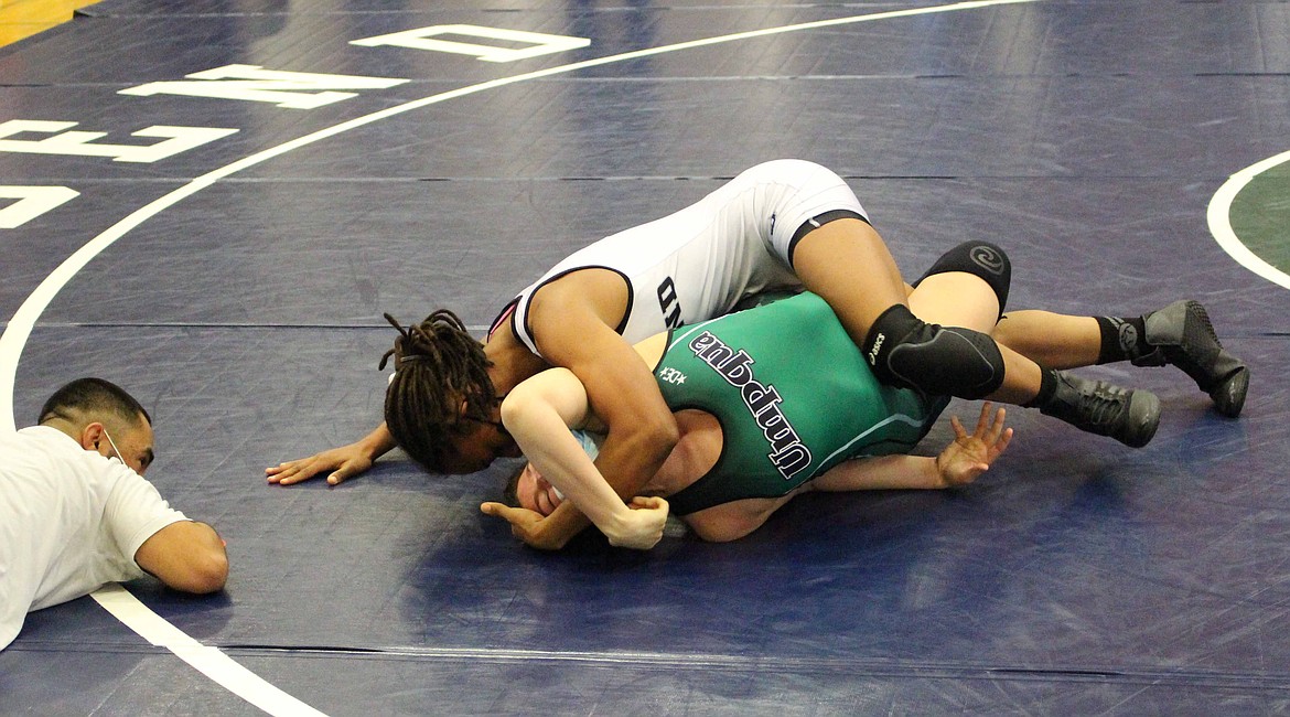 Aliyah Yates works on flipping her opponent to her back on the mat on Saturday afternoon at Big Bend Community College.