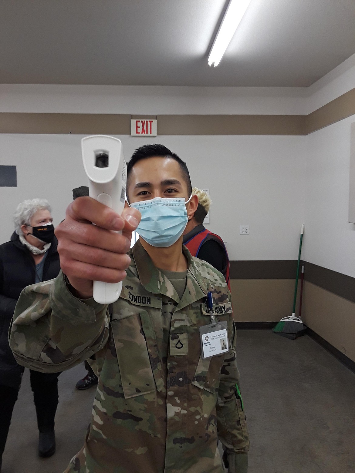 PFC Tyronne Condon of the Idaho National Guard checks in visitors at the Panhandle Health vaccination clinic with a temperature check inside the Kootenai County Fairgrounds. The COVID-19 vaccine fervor in early February that materialized as seniors became eligible has since died down. (CRAIG NORTHRUP/Press)