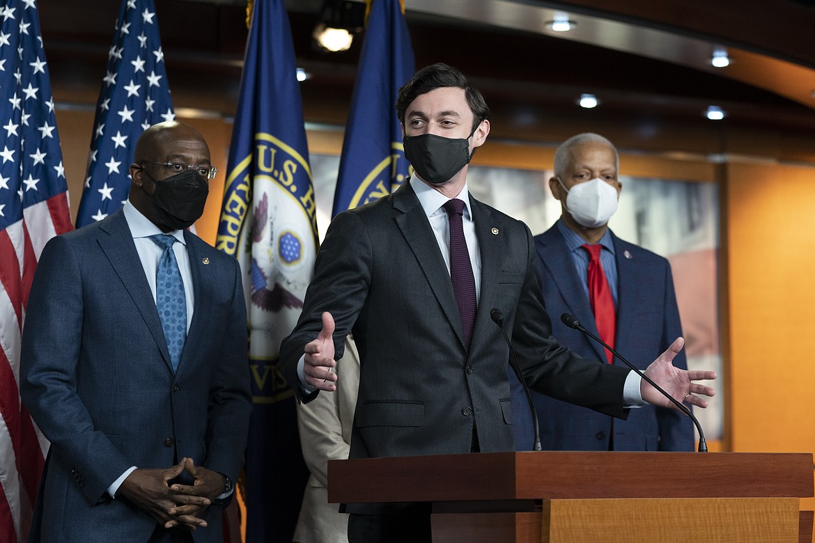 Sen. Jon Ossoff, D-Ga., center, speaks accompanied by Sen. Raphael Warnock, D-Ga., left, and Rep. Hank Johnson, D-Ga., during a news conference, before the vote on the Democrat's $1.9 trillion COVID-19 relief bill, on Capitol Hill, Wednesday, March 10, 2021, in Washington. (AP Photo/Alex Brandon)