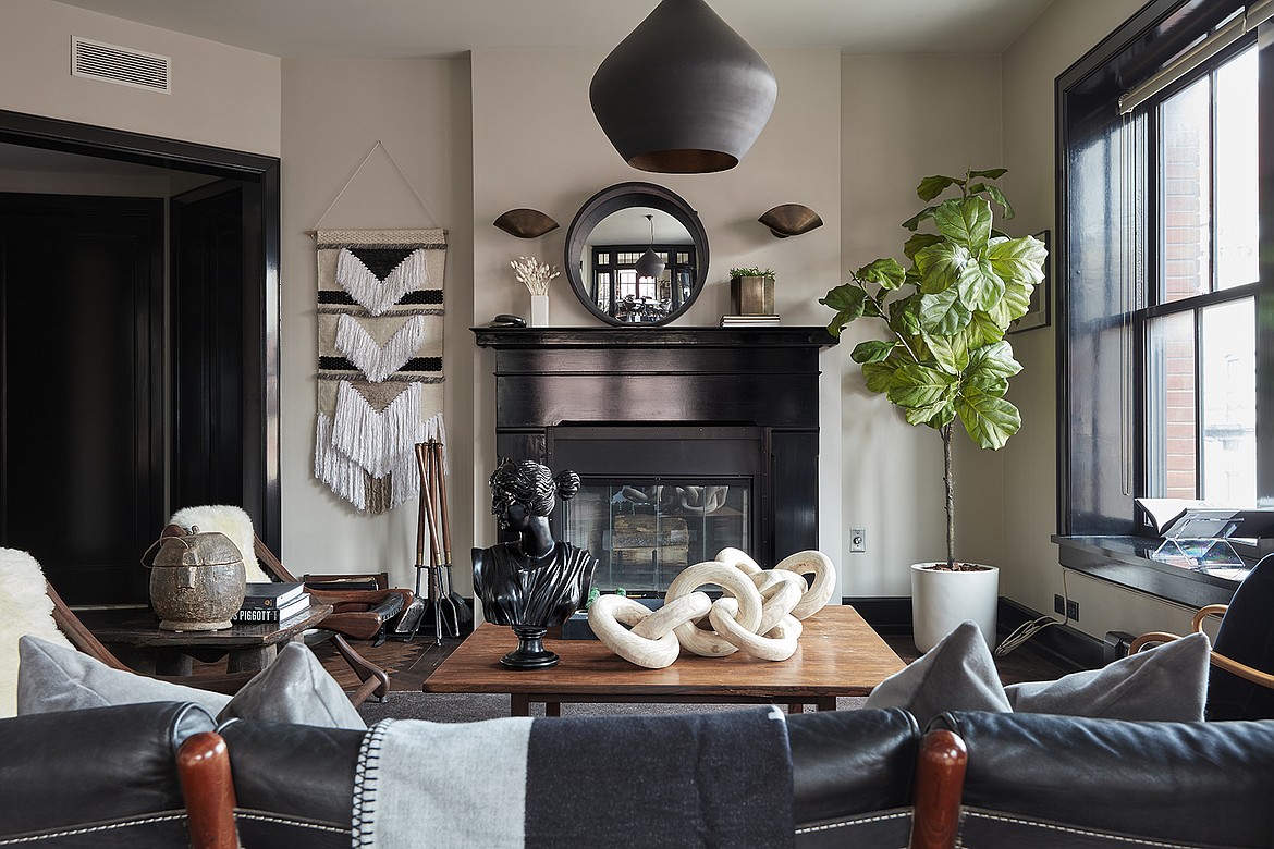 Black dominates this living space, from light fixtures to paint trim. White creates a strong sense of contrast.