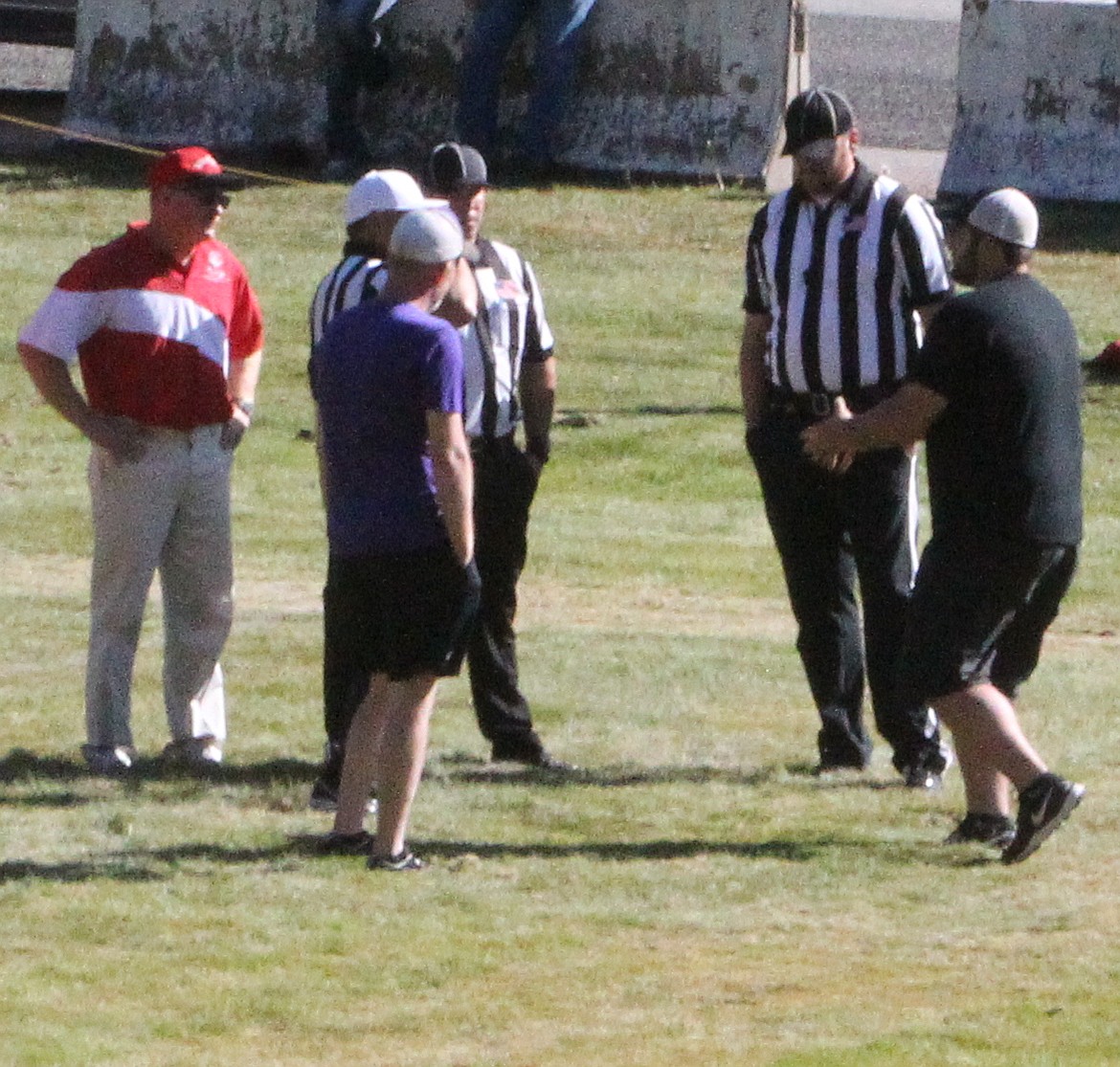 JASON ELLIOTT/Press
Kootenai football coach Doug Napierala meets with referees before the start of a 2016 game against Mullan at John Drager Field. Napierala, 55, stepped down as football coach and athletic director at Kootenai High after 20 years earlier this month.