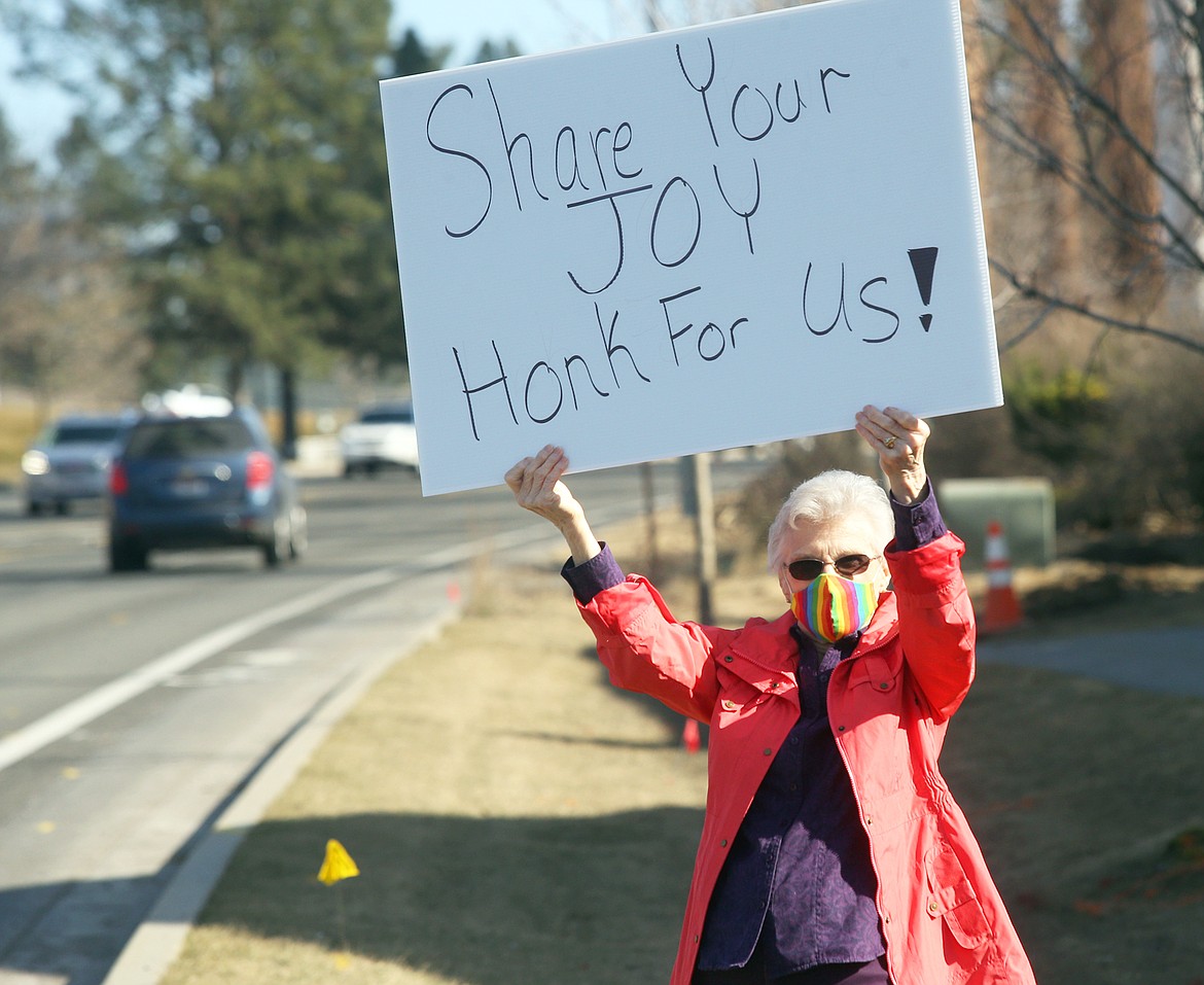 Dixie Merriman stands along Seltice Way Friday afternoon during a rally by some North Star Retirement and Assisted Living Community members to spread a positive message of joy and happiness.
