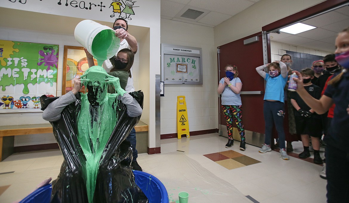 Fifth-grader Isabella Taylor and Ramsey Magnet School of Science Assistant Vice Principal Aaron Drake on Friday pour green goo on P.E. teacher Trena Burt to celebrate reaching the school's fundraising goal for the Kids Heart Challenge.  Isabella was the top individual fundraising student with $652.22.