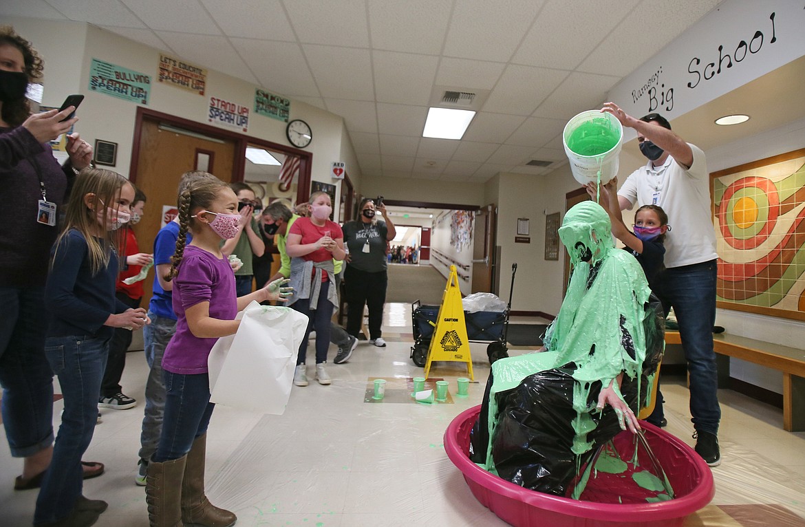 Second-grader Kayla McClellan and Vice Principal Aaron Drake pour slime on Principal Crystal Kubista on Friday to celebrate Ramsey Magnet School of Science raising more than $8,500 for the Kids Heart Challenge. Kayla placed second by collecting $568.48.
