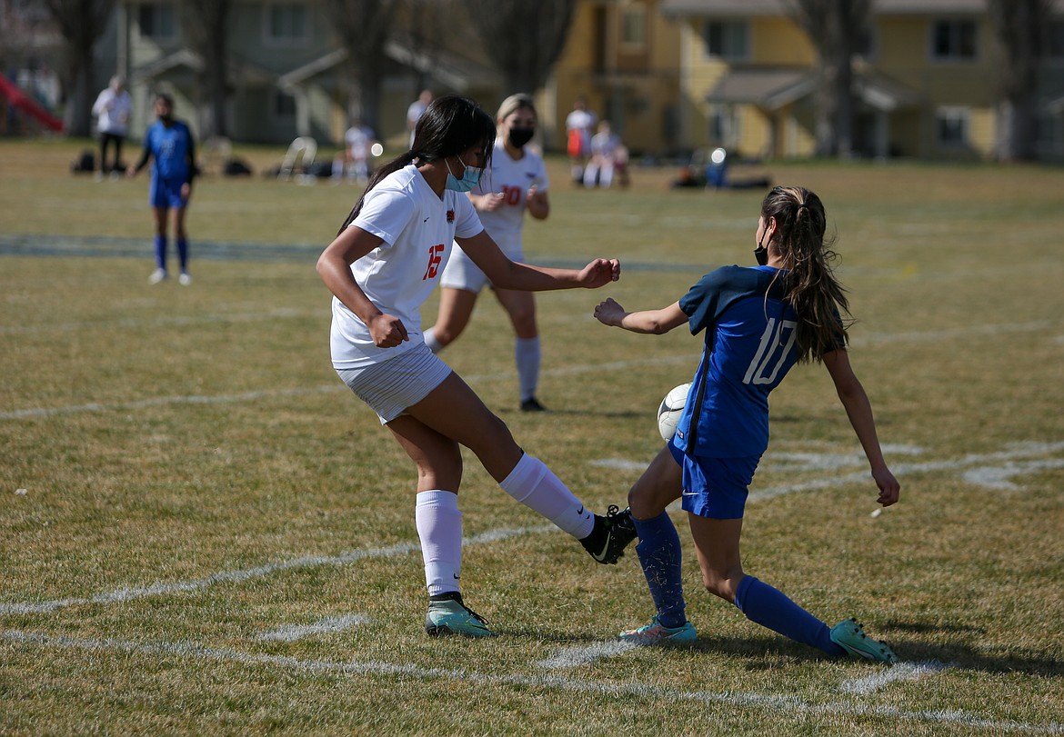 Ephrata defender Alessa Soto fights for the ball with Warden's Arely Rangel in the Tigers' 7-0 win at Warden High School on Saturday afternoon.