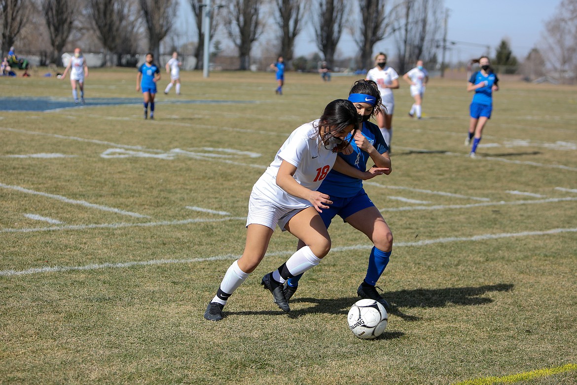 Ephrata's Anahi Vargas (18) battles for the ball with Warden's Dezarai Gonzalez on Saturday afternoon at Warden High School.