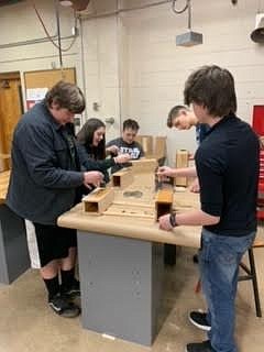 Noxon School students, from left, Easton Hanley, Emily Brown, Gage Hendrick, Jacob King and Shamus Wheeldon work on the wooden boxes which will hold the ashes of veterans who have served their country. (Photo courtesy Noxon School)