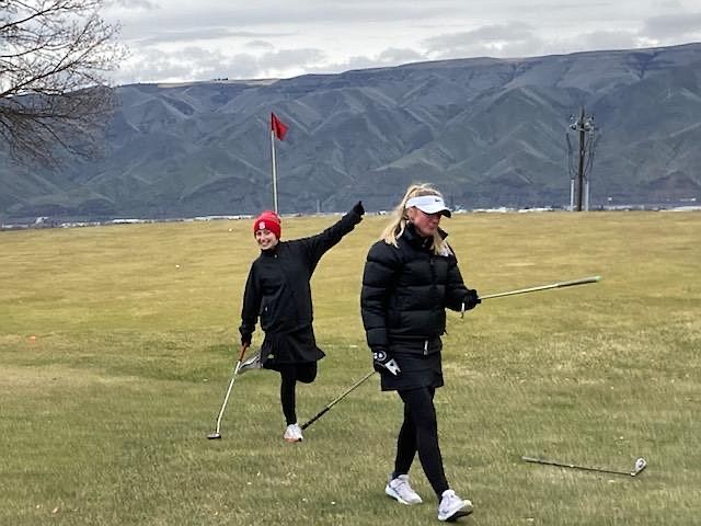 Sandpoint's Camille Neuder (left) and Annaby Kanning have some fun while walking off the green on Monday. The pair tied for the best scramble score on the girls side.