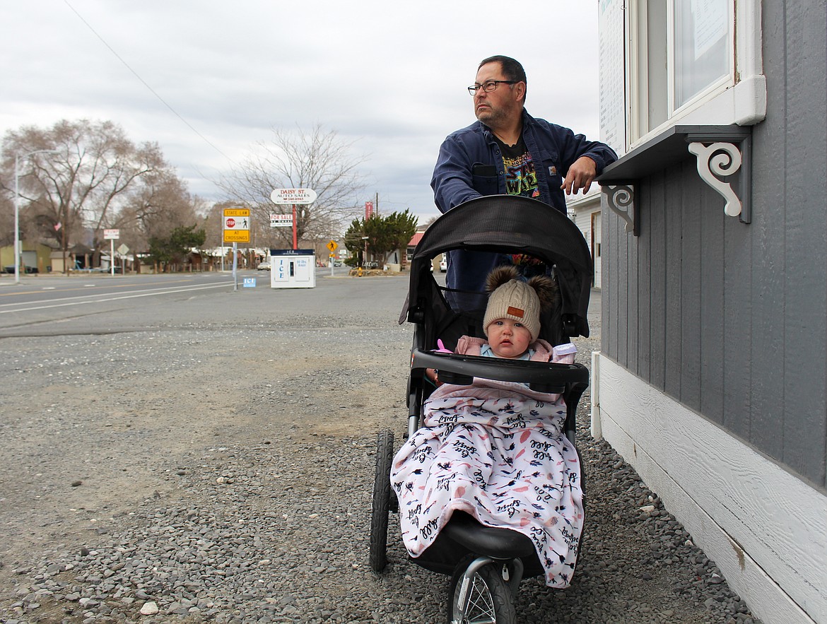 Joe Nitta and his granddaughter, Callie, stop by The Busy Bean coffee stand in Soap Lake while out for a walk on Monday afternoon.