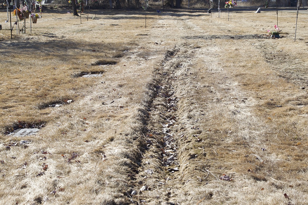 Deep tire ruts could be seen above graves at the Libby Cemetery March 16. (Will Langhorne/The Western News)