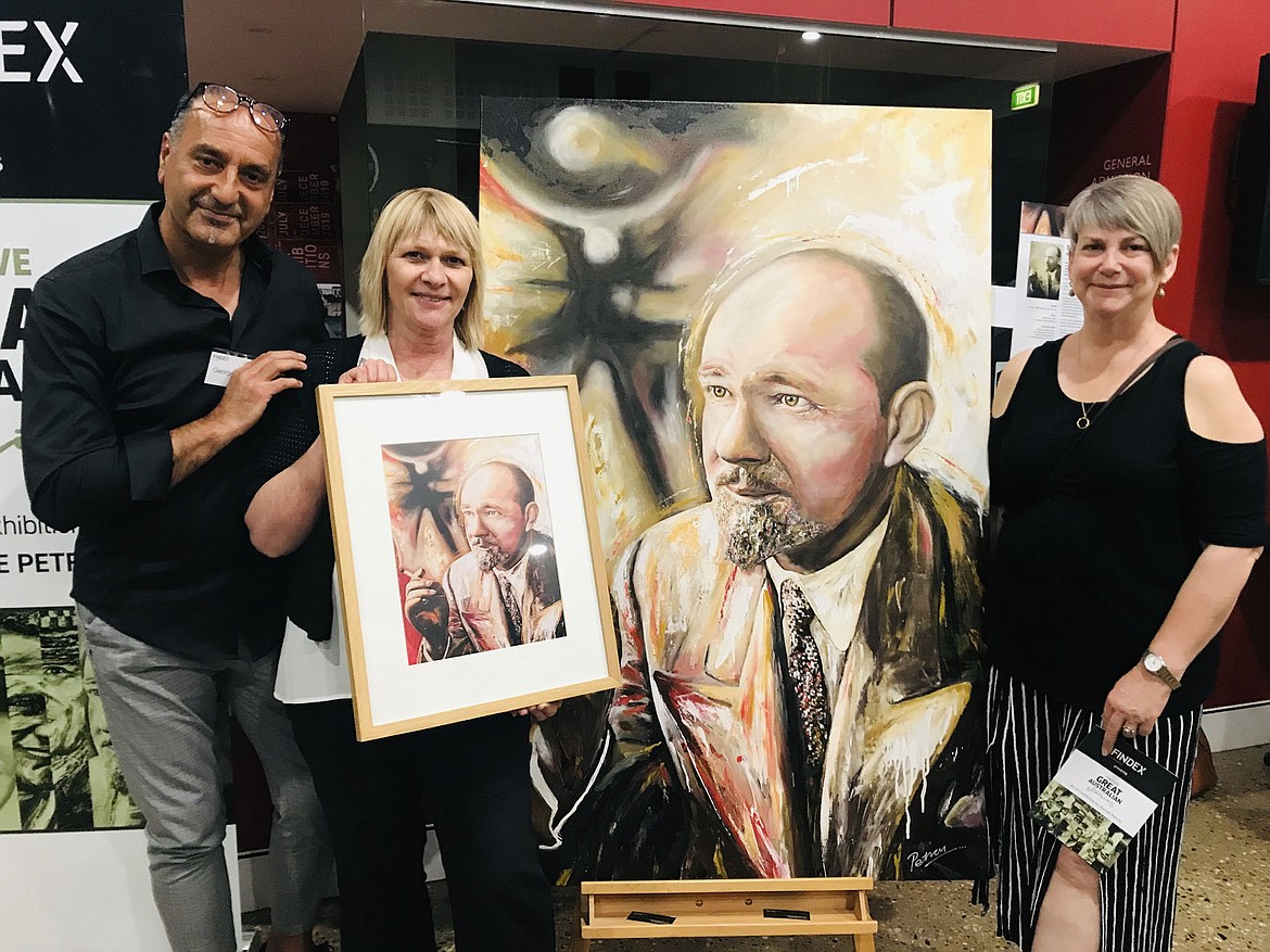 Australian artist George Petrou (left) with winners of door prize print of his painting of Sir Hubert Wilkins presented by the Wilkins Foundation.