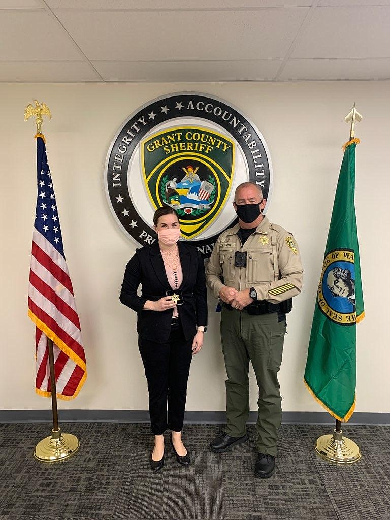 New Grant County Sheriff's Office detective Kristina Ball receives her gold shield from Grant County Sheriff Tom Jones March 8. Ball is the first female detective at the sheriff's office.