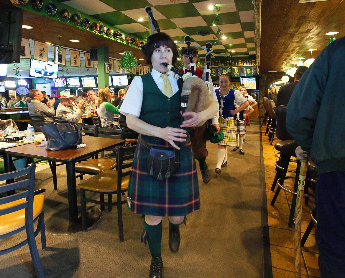 Kristin Stafford plays the bagpipes as she leads the Lake City Highland Dancers from Paddy's Sports Bar on Wednesday.