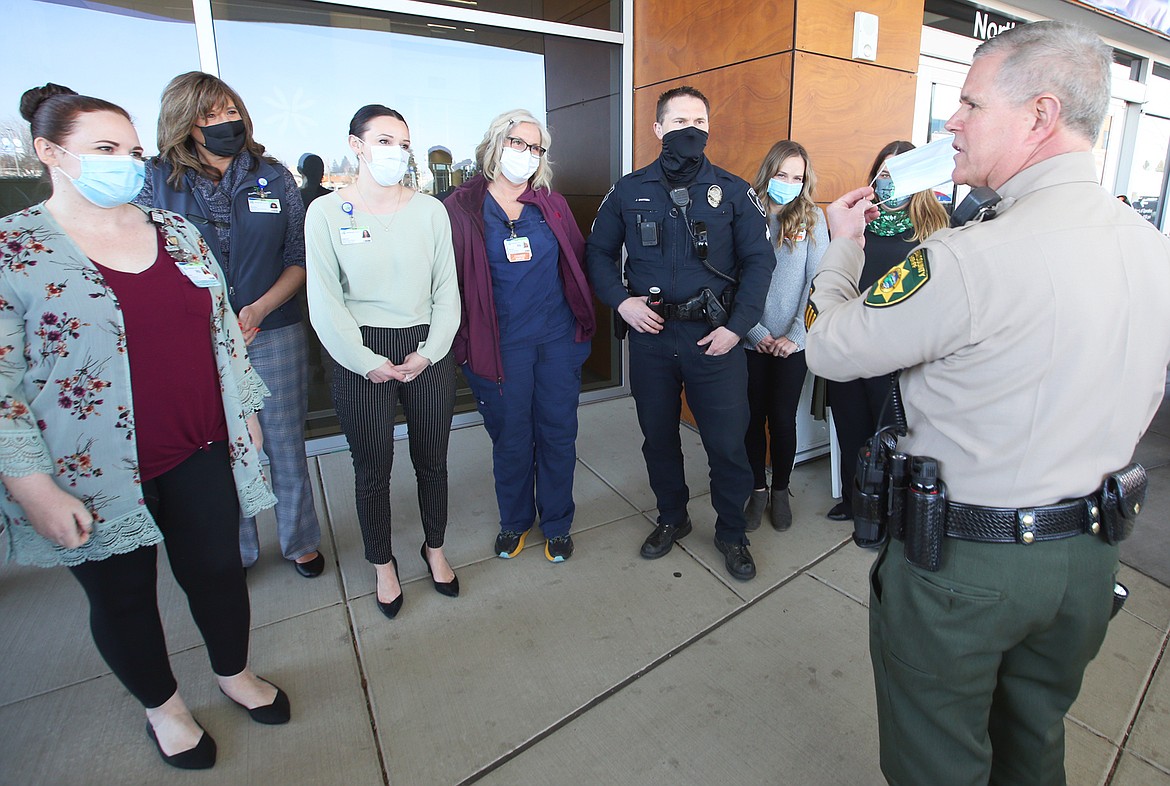 Sheriff Bob Norris talks to Kootenai Health staff and a police officer after delivering free lunches there Wednesday.