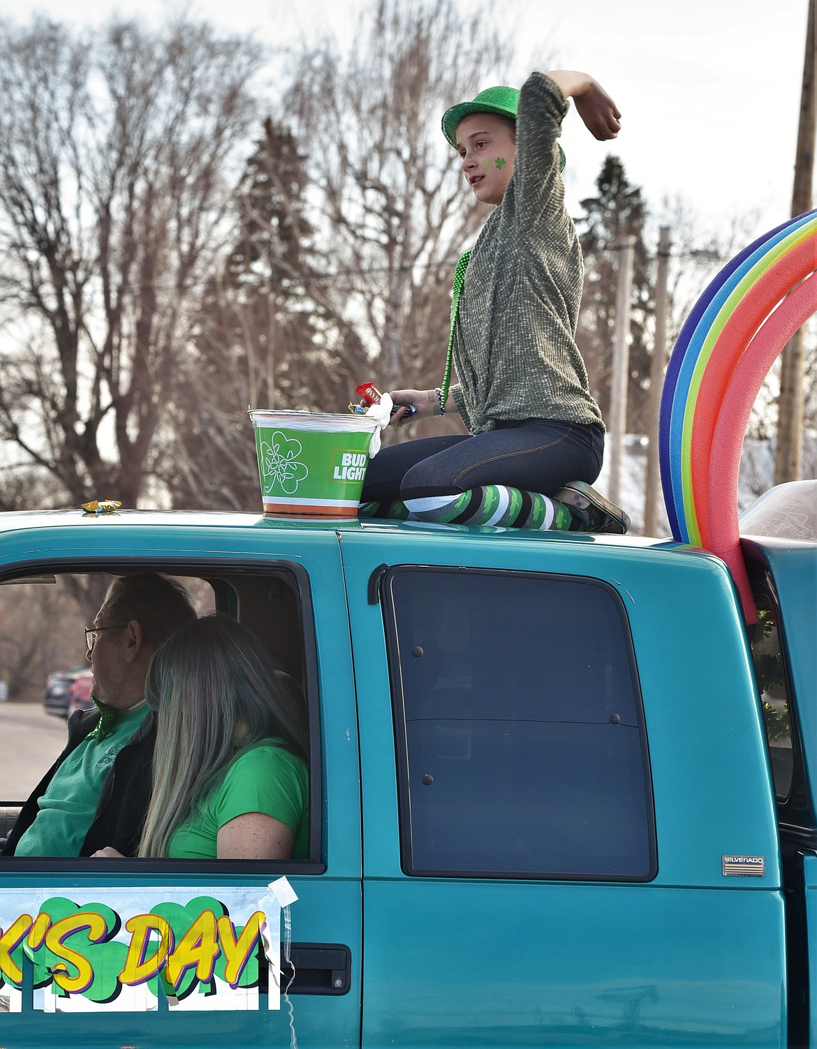 Natalia Turpin tosses candy from atop a pickup Wednesday during the St. Patrick's Day Parade in Ronan. (Scot Heisel/Lake County Leader)