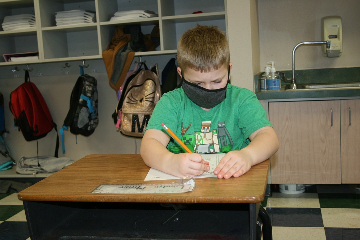 Soap Lake first grader Landyn Miner works on a lesson Thursday. Operation in the time of the COVID-19 pandemic has been different for each school district in the area.