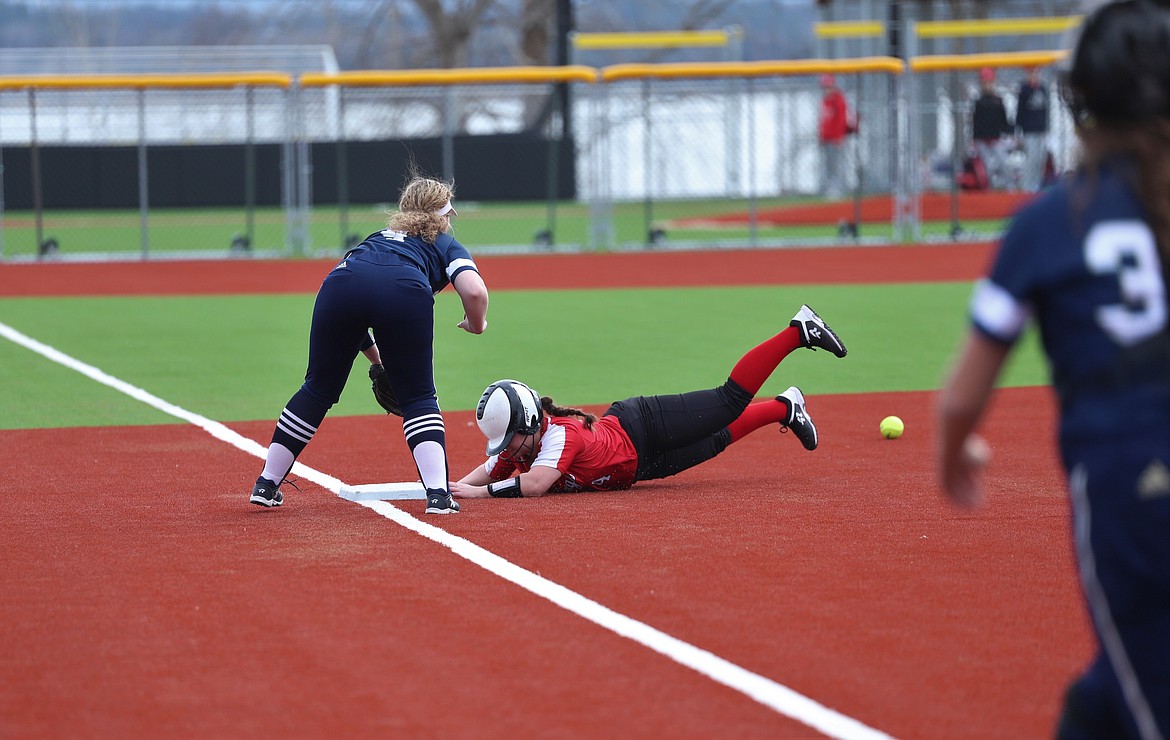 Senior Kinzie Ward dives head first into third base for a triple on Thursday.