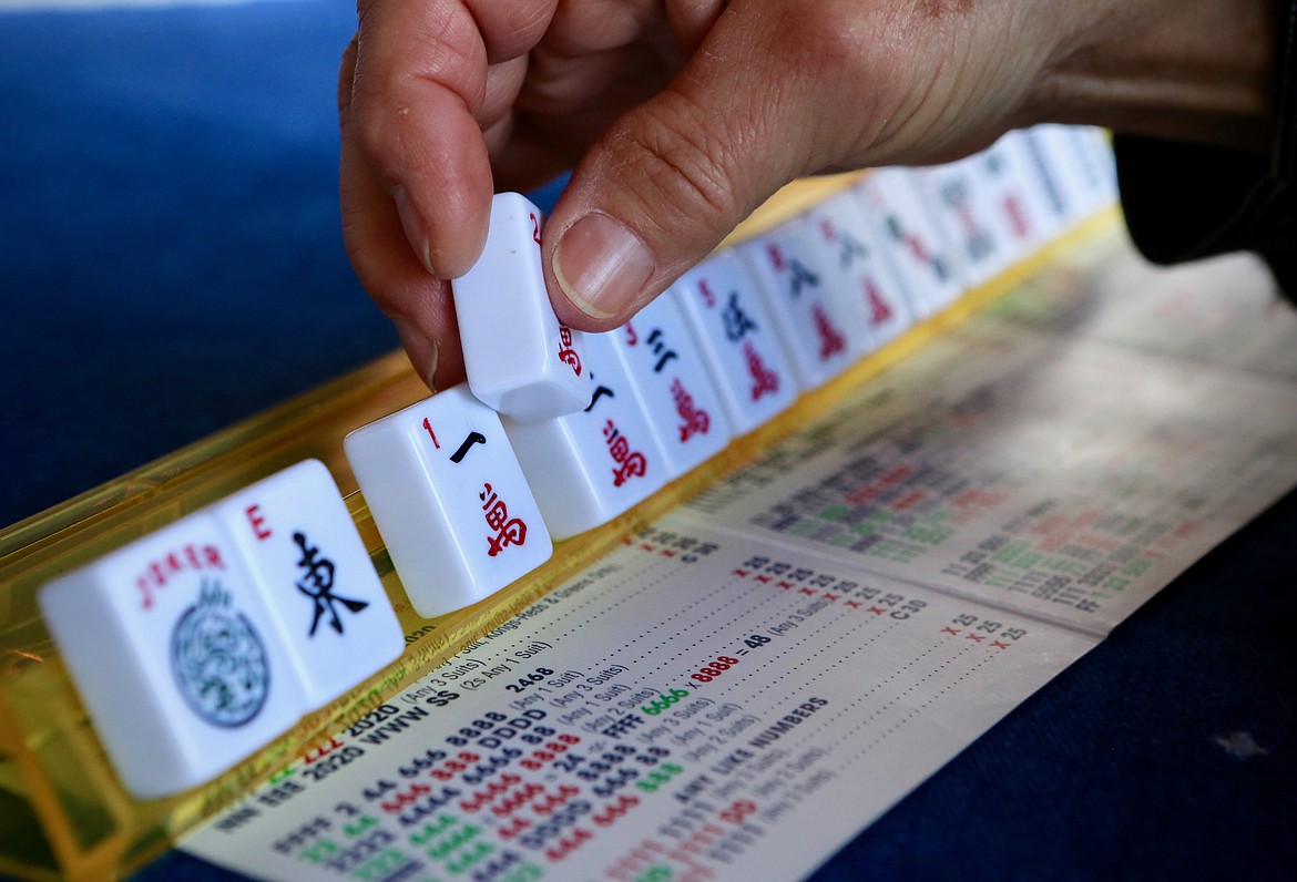 Jan Thompson sorts through mahjong tiles Friday, March 12. 
Mackenzie Reiss/Bigfork Eagle