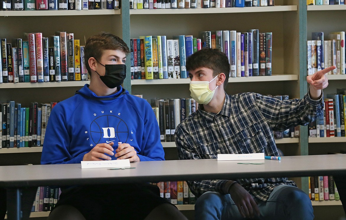 Coeur d'Alene High sophomores Alexander Nipp, left, and Dylan Jones chat before the first in-person meeting of the Student Advisory Group in the Lake City High library Wednesday afternoon.