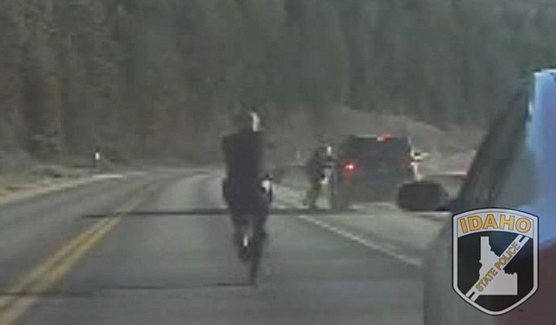 An Idaho State Police trooper chases a suspect on Highway 95 near Cocolalla Lake on Tuesday.