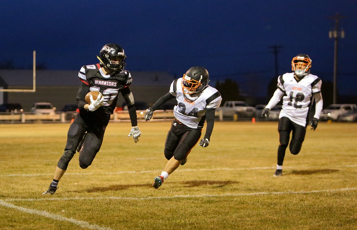 Grady Murray bursts down the outside of the field against Bridgeport on Friday night at Almira-Coulee-Hartline High School.