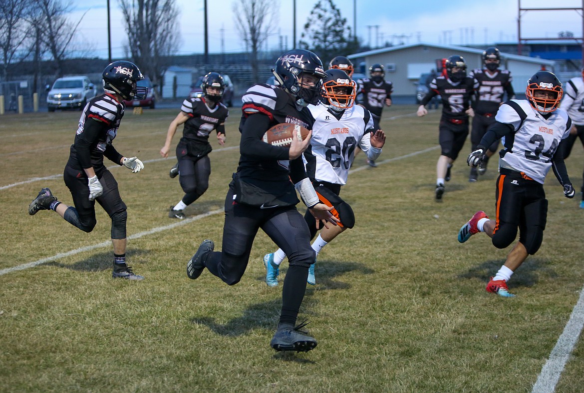 ACH quarterback Dane Isaak bursts down the field for the rushing touchdown on the opening play of the game against Bridgeport on Friday night in Coulee City.