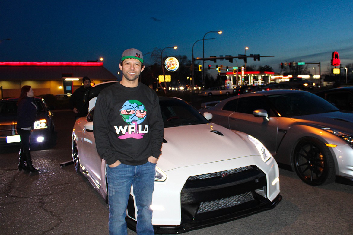 Othello resident Javi Ramirez poses in front of his Nissan GT-R at the car meetup in Moses Lake on Saturday.