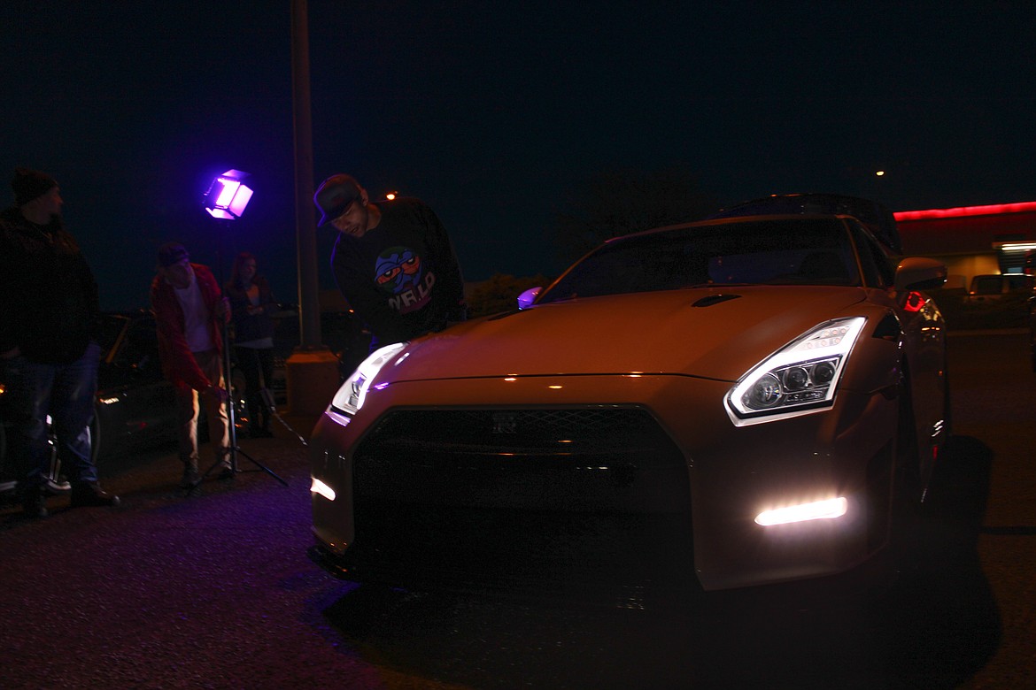 Othello resident Javi Ramirez polishes his Nissan GT-R at the car meetup in Moses Lake on Saturday.