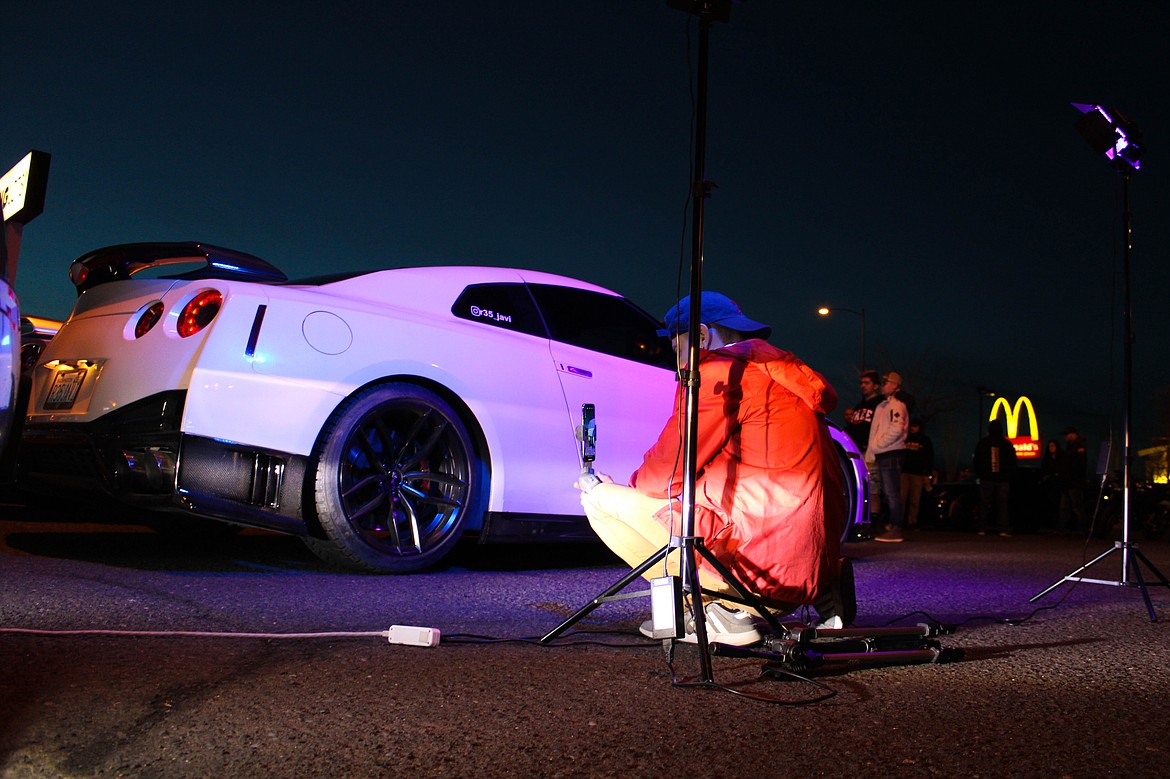 Edgar Dominguez takes photos of a Nissan GT-R at the car meetup in Moses Lake on Saturday.