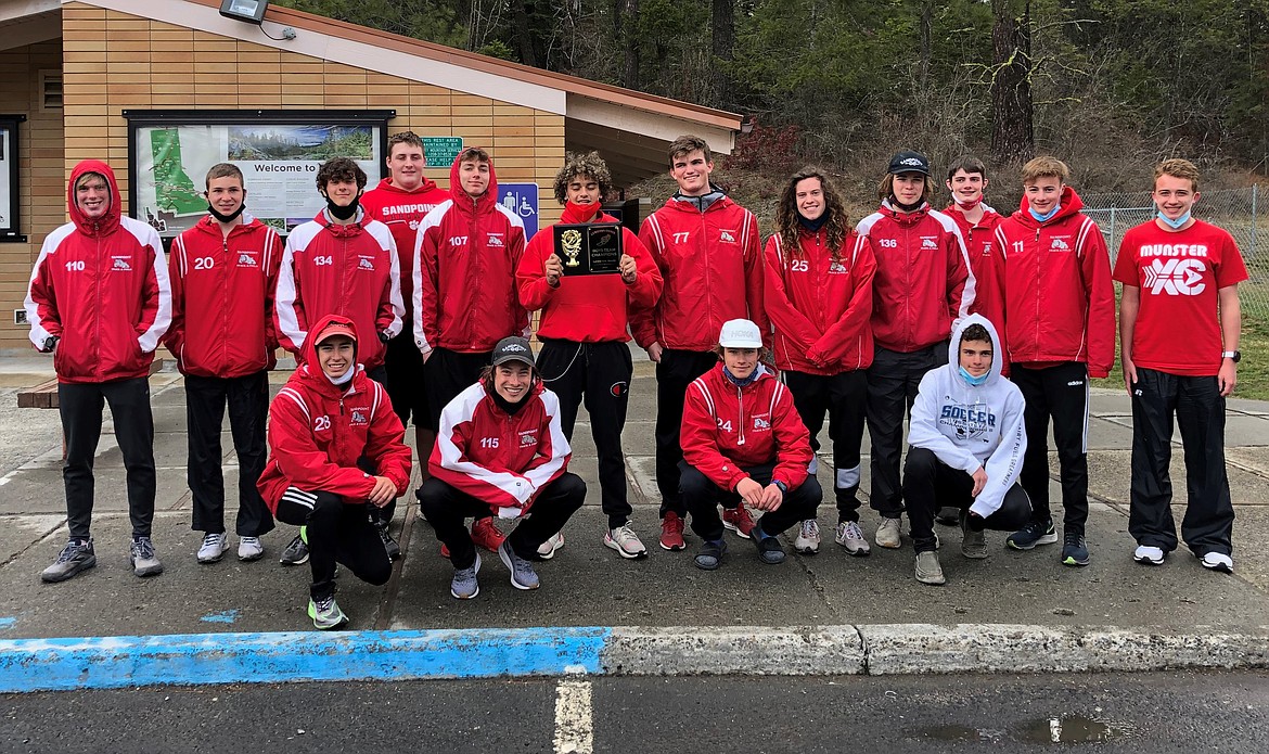 The boys track team poses for a photo with the plaque they earned by capturing first at the Lewiston Invitational on Saturday.