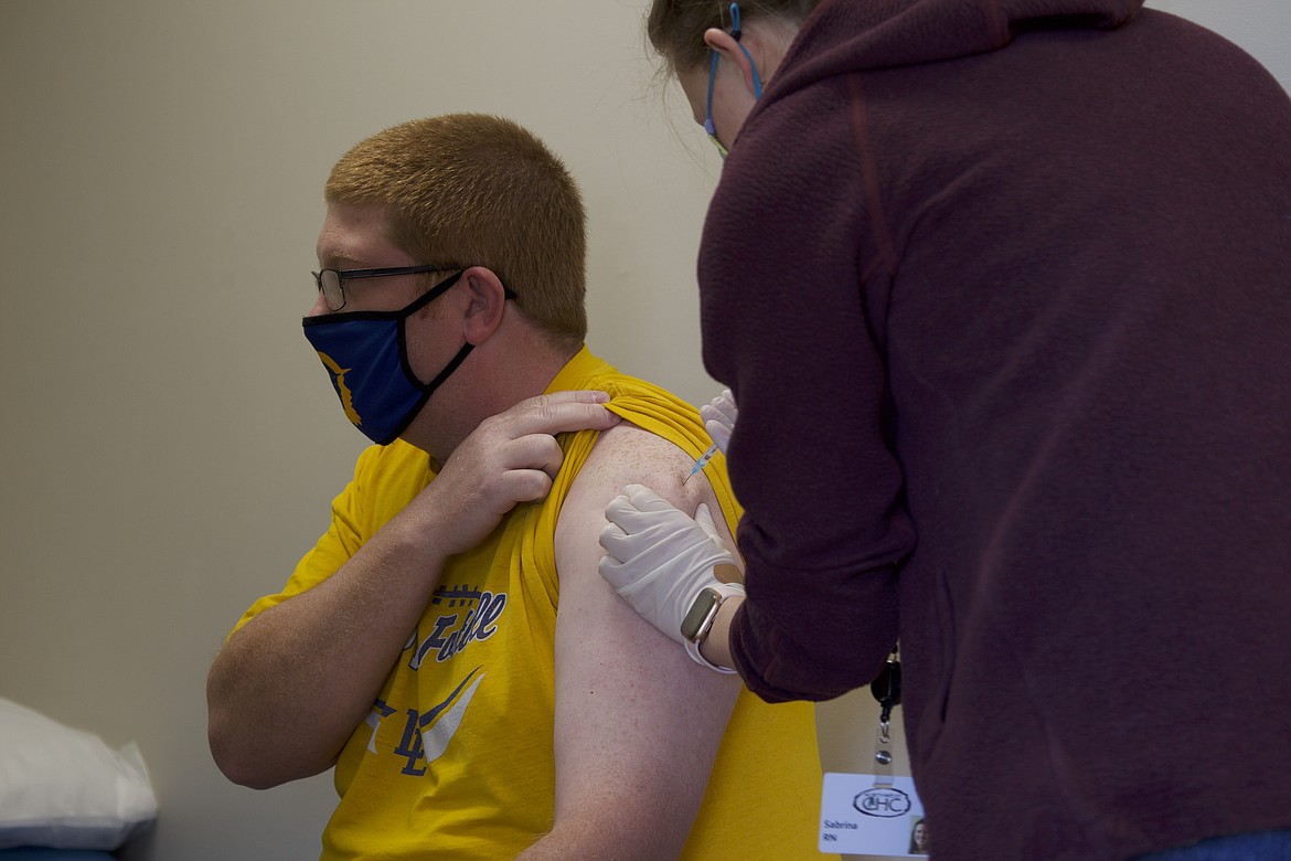 Sabrina Smith, Libby Elementary School nurse, administers a vaccine to Josh Bean, Libby Middle High School teacher March 18. Libby and Troy Public School staff were able to receive doses of the coronavirus vaccine through the Federal Retail Pharmacy Program. The program, a nationwide push to vaccinate educators, included Granite Pharmacy in its network of local pharamacies. (Will Langhorne/The Western News)