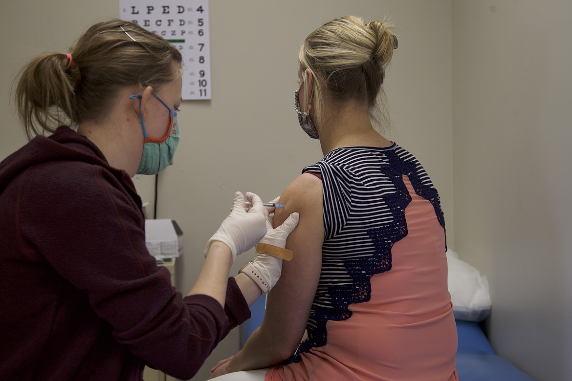 Sabrina Smith, Libby Elementary School nurse, administers a vaccine to Sam Hannah, Libby Elementary School teacher March 18. Libby and Troy Public School staff were able to receive doses of the coronavirus vaccine through the Federal Retail Pharmacy Program. The program, a nationwide push to vaccinate educators, included Granite Pharmacy in its network of local pharamacies. (Will Langhorne/The Western News)
