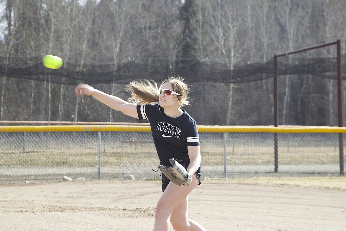 Sophomore Kinzee Boehmler launches a softball during practice March 18. (Will Langhorne/The Western News)