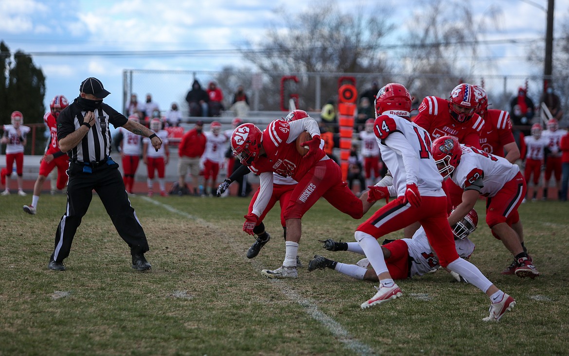 Othello running back Julian Alegria rumbles forward against Clarkston at Huskie Stadium on Saturday afternoon in Othello.