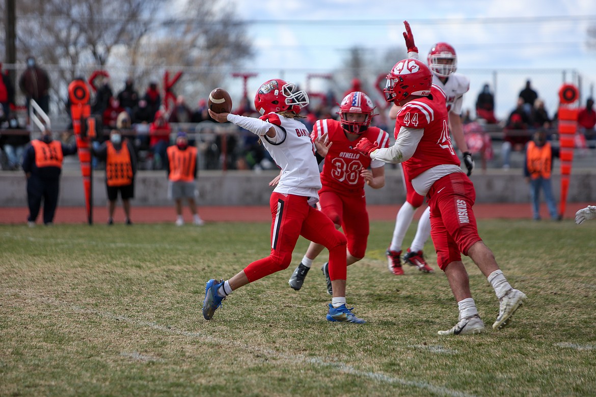 Othello's Julian Alegria jumps up to contest the pass, leading to an interception in the Huskies' win over Clarkston on Saturday afternoon in Othello.