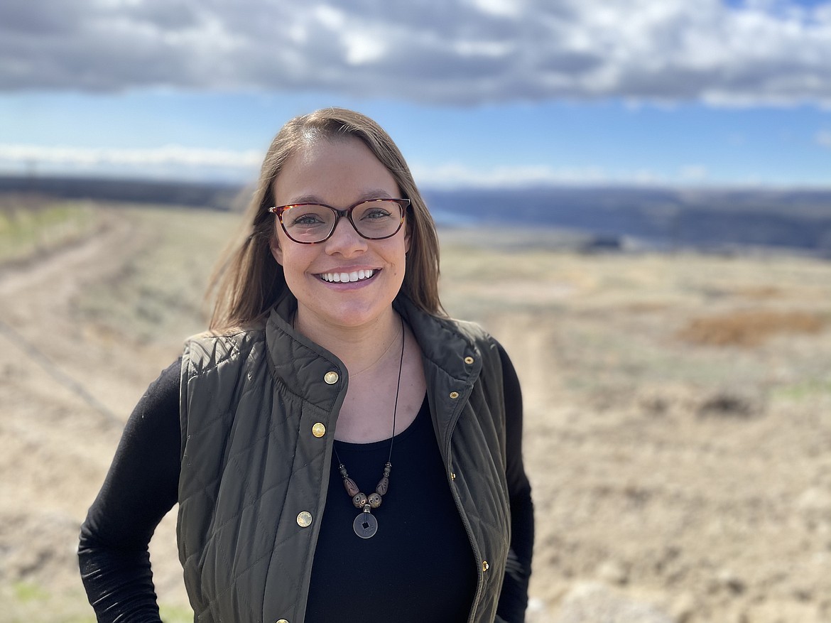 Katie Karstetter, owner of Quincy-based Columbia Natural, which makes lotions with CBD to treat pain, stands on family farmland overlooking the Columbia River. Karstetter originally went to school to be a preschool teacher, but later found herself in a lab distilling CBD from hemp. "I've always been scientifically minded," she said.