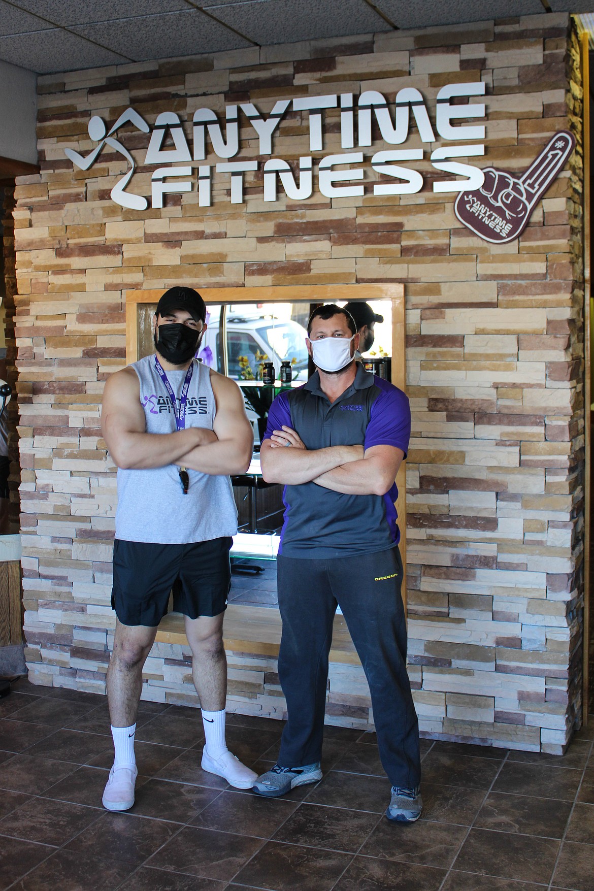 Managers Leo Garcia (left) and Tod Haneberg (right) pose at Anytime Fitness at 514 Basin Street in Ephrata.