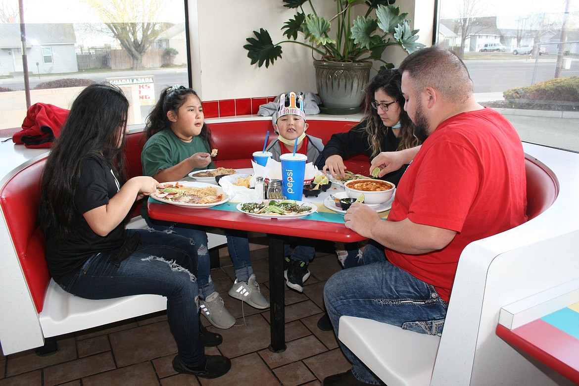 (From left) Giselle, Mila and Armani Fuentes, their mom Karina Marroquin and dad Mike Fuentes celebrate a birthday at Guadalajara Restaurant in Othello. Monday was the first day Businesses were allowed to operate at 50% of building capacity