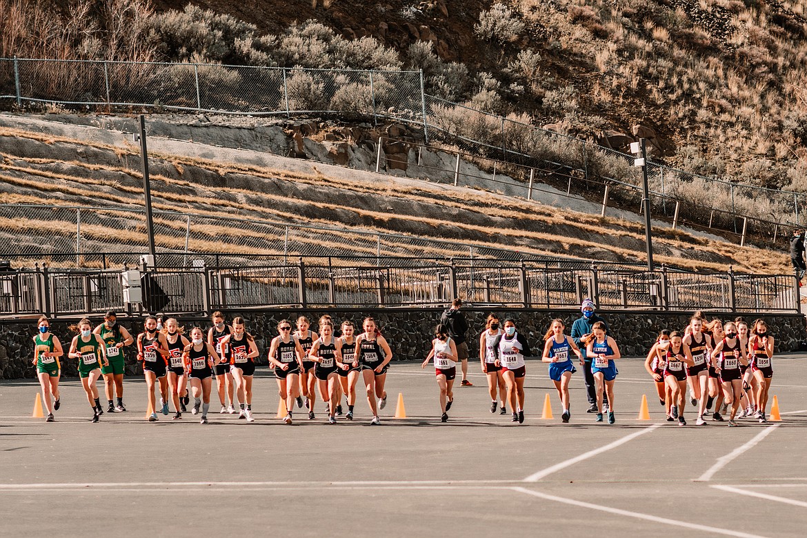 Runners leave the starting line as the girls 5,000 meter race kicks off the North Central Region cross country meet at the Gorge Amphitheater on Saturday.