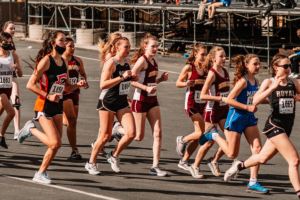A mix of cross country runners from North Central Region schools pass in front of the stage at the Gorge Amphitheater on Saturday in George.