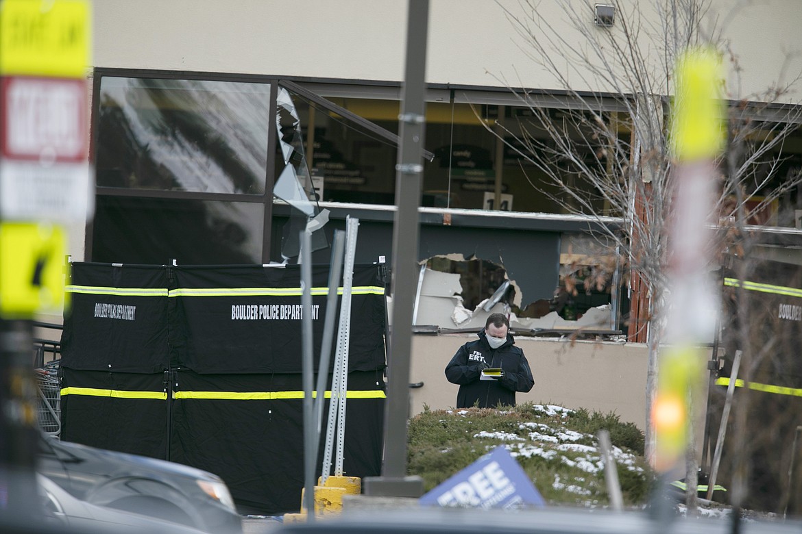 Police work on the scene outside of a King Soopers grocery store where authorities say multiple people were killed in a shooting, Monday, March 22, 2021, in Boulder, Colo.