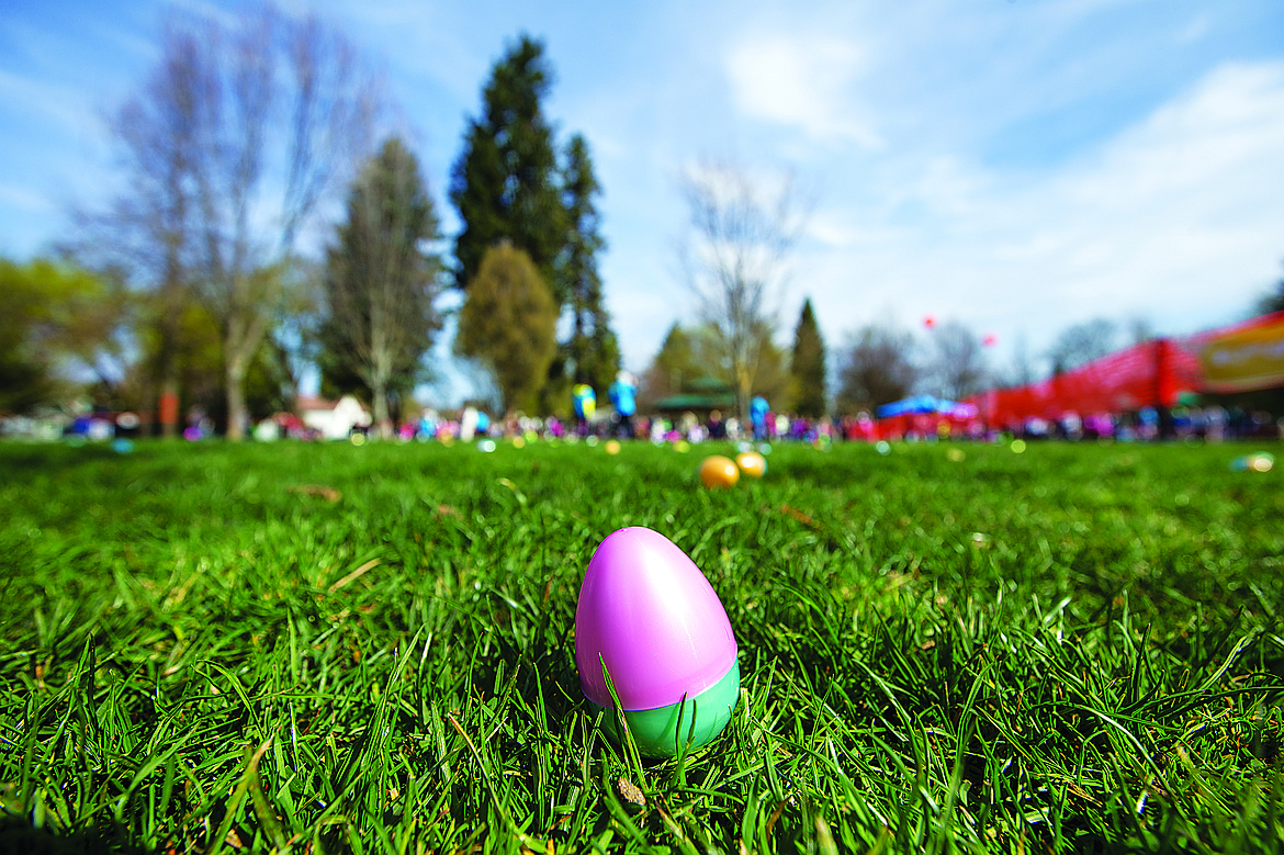 A brightly colored plastic egg lies in the grass as children await the start of the Real Life Ministries Easter egg hunt at Phippeny Park in Coeur d’Alene in 2014.
GABE GREEN/Press File