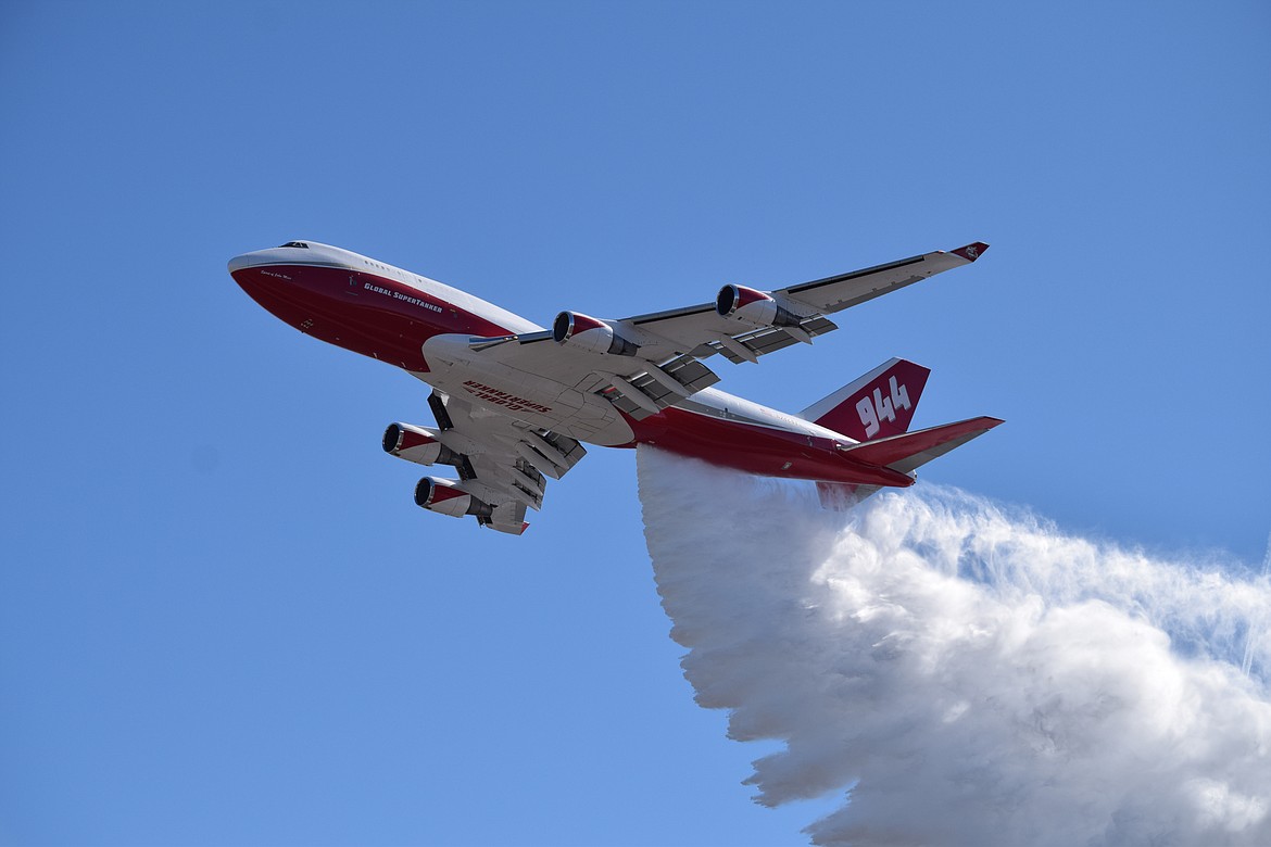 Global Supertanker, a 747 modified to fight wildfires, drops nearly 20,000 gallons of water on the main runway on Tuesday from an altitude of 500 feet as part of a test of the plane's new systems, installed over the last month by AeroTEC in its Moses Lake facility. The plane normally drops water and fire retardant on wildfires from 250 feet, according to Global Supertanker Chief of Operations John Winder, but flew at a higher altitude Tuesday as part of the test.